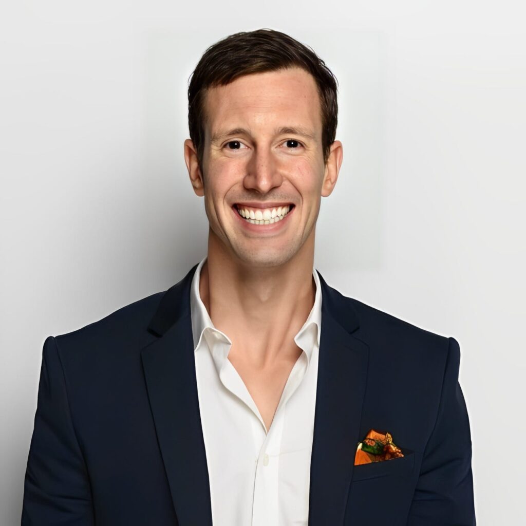 Sean Cook, founder of the Tea Dating App, smiling in a navy blazer with a white shirt.