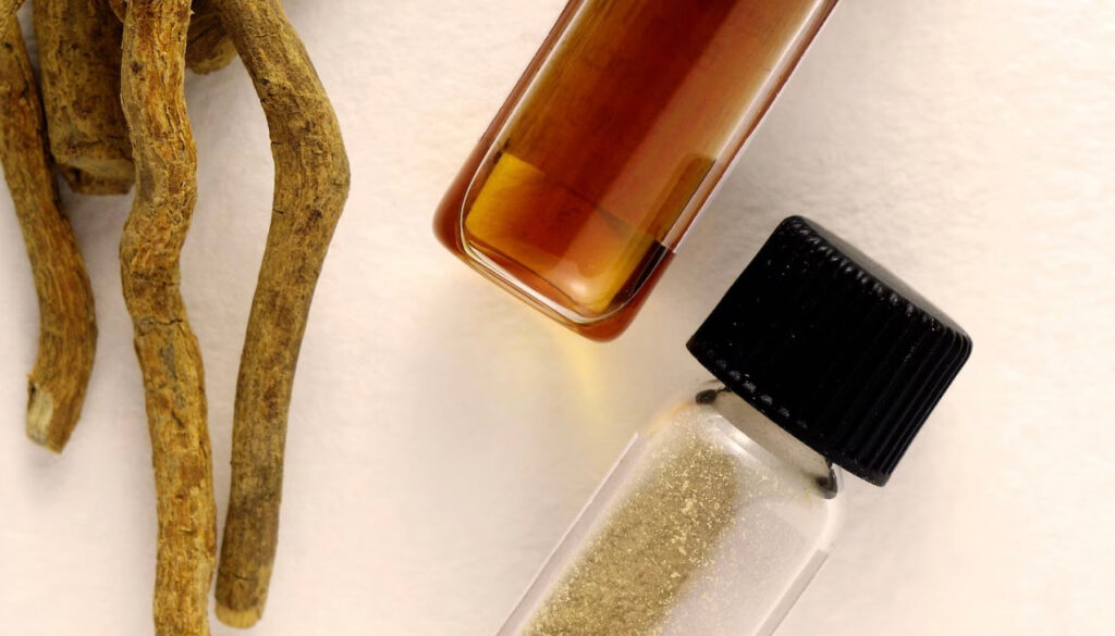 Close-up photo of iboga root with two small glass vials containing liquid and powder, representing natural ibogaine used in comparison to ketamine and MDMA therapy.