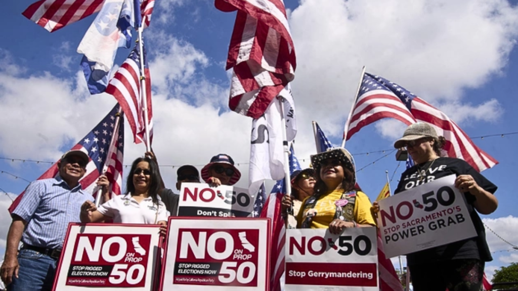 Protestors holding signs that say 'No on Prop 50' during a rally against California's Prop 50, warning of the political power grab.