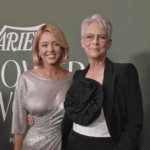 Sydney Sweeney and Jamie Lee Curtis posing together on a red carpet in front of a green and white background. Sydney Sweeney is smiling at the camera with her arm around Jamie Lee Curtis, who is also smiling softly at the camera.