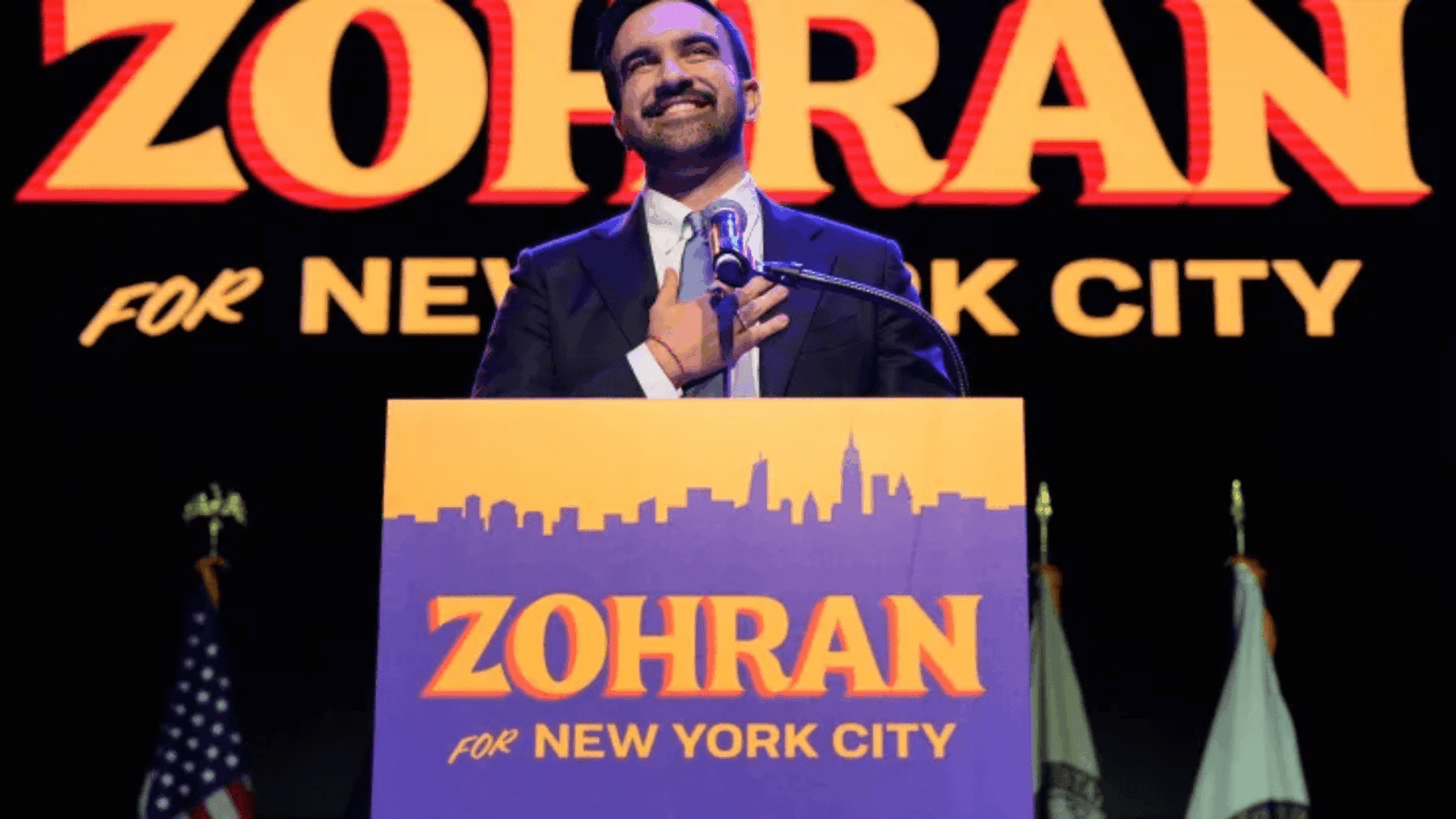 A dynamic photo of Zohran Mamdani raising his fist in celebration against a backdrop of supporters, symbolizing his major political victory to become Zohran Mamdani NYC Mayor