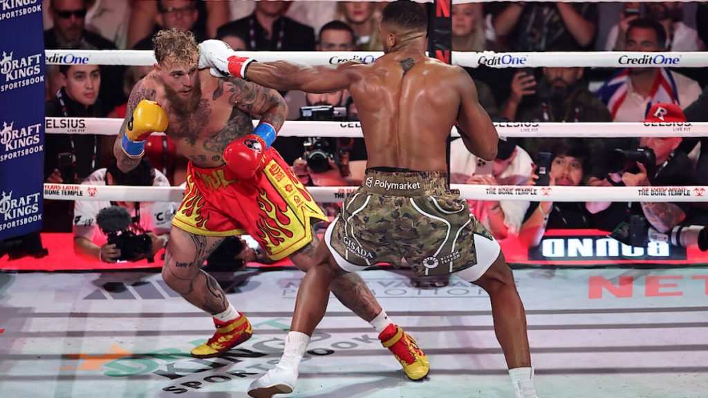 Dramatic imagery from the Jake Paul vs Anthony Joshua event on Netflix, illustrating the 6th-round knockout victory by Anthony Joshua that ended the crossover boxing hype.