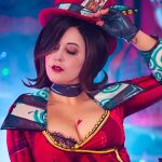 Meg Turney wearing a Mad Moxxi cosplay from the Borderlands video game series, featuring cel-shaded makeup and a red ringmaster outfit.
