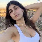 Adult star and social media influencer Mia Khalifa posing in front of a rocky desert background.