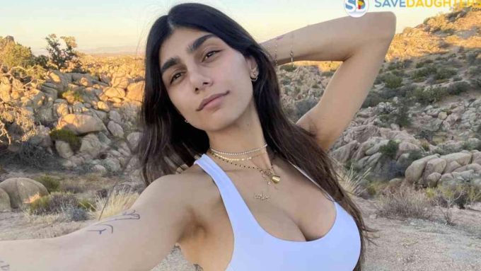 Adult star and social media influencer Mia Khalifa posing in front of a rocky desert background.