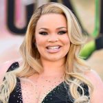 Close-up of Trisha Paytas featuring glamorous makeup and wavy blonde hairstyle at a premiere.