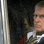 A close-up, dramatic shot of Prince Andrew looking out of a rain-streaked car window. He has a stern, concerned expression. To the left, a faint reflection of a woman is visible in the glass. Superimposed text at the top reads: "Prince Andrew Arrested: Former Royal Faces Criminal Charges Linked to Epstein Files."