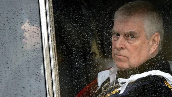 A close-up, dramatic shot of Prince Andrew looking out of a rain-streaked car window. He has a stern, concerned expression. To the left, a faint reflection of a woman is visible in the glass. Superimposed text at the top reads: "Prince Andrew Arrested: Former Royal Faces Criminal Charges Linked to Epstein Files."