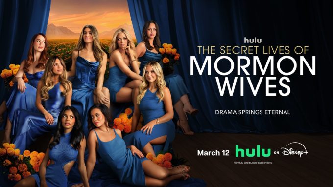 The official promotional poster for The Secret Lives of Mormon Wives features eight cast members posed together against a dramatic backdrop of blue curtains. The women are all dressed in various shades of vibrant blue gowns, surrounded by clusters of orange marigolds. The background reveals a sunset over a mountain range and a field of flowers. Text on the poster reads "hulu THE SECRET LIVES OF MORMON WIVES," "DRAMA SPRINGS ETERNAL," and lists a release date of "March 12" on Hulu and Disney+.