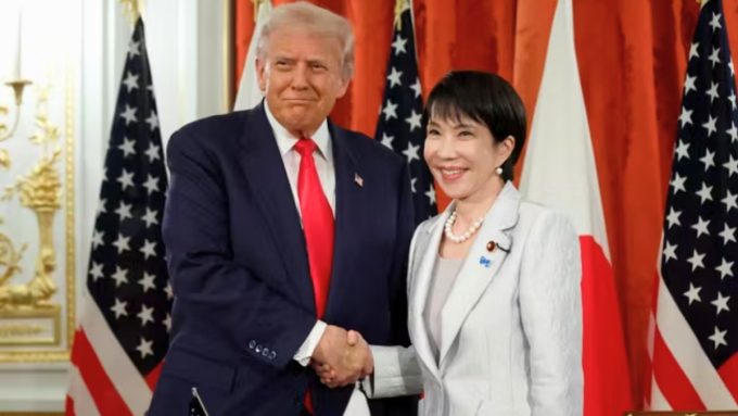 President Donald Trump and Japanese Prime Minister Sanae Takaichi are pictured during a formal meeting at the Akasaka Palace in Tokyo. They are seated at a large conference table with their respective delegations, following the announcement of a $36 Billion US Investment from Japan as the first tranche of a larger trade agreement.