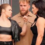 MMA legends Gina Carano and Ronda Rousey face off at the Intuit Dome press conference for their 2026 Netflix fight night. Gina Carano (right) and Ronda Rousey (left) stand on either side of Jake Paul during the Most Valuable Promotions event.
