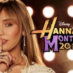 A promotional graphic for the Hannah Montana 20th Anniversary Special featuring a close-up of Miley Cyrus holding a finger to her lips in a "shushing" gesture; the official Disney logo and anniversary title are displayed prominently against a backdrop of warm, blurred stage lights.