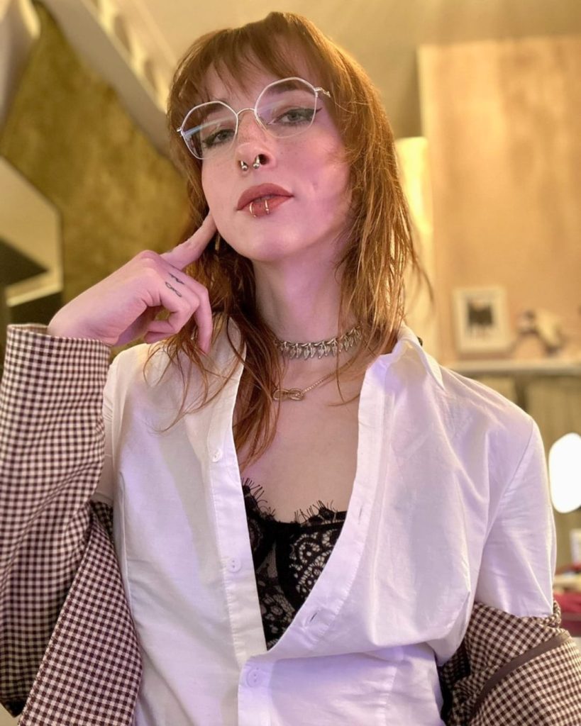 Lily Kitsune portrait wearing glasses and white shirt with red hair – transgender OnlyFans influencer and content creator.