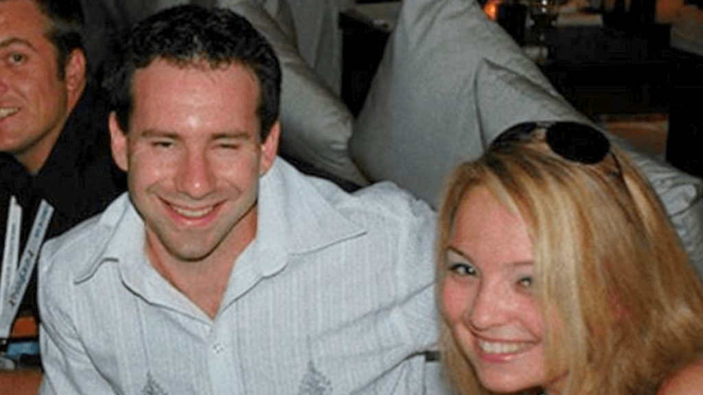 A vintage, candid photo of Leonid Radvinsky and Katie Chudnovsky smiling together at a social event.