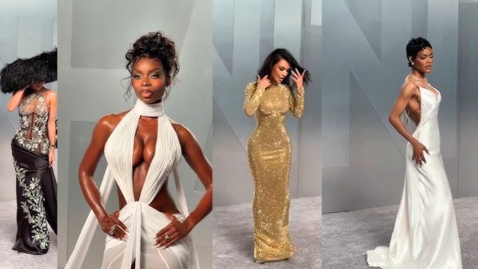 A composite of four glamorous celebrities posing on a grey carpet. Looks include an avant-garde feathered hat and sheer gown, a white keyhole cutout dress, a shimmering gold long-sleeve gown, and a sleek white gown with a chained back.