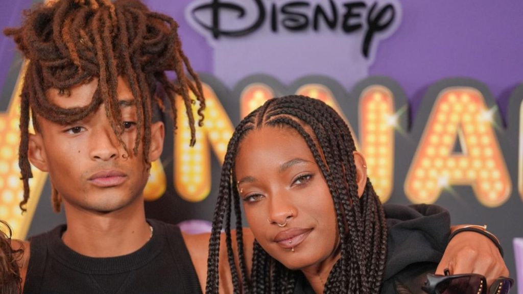 Willow Smith with dreadlocks smiling and Jaden Smith with braids next to him at the Hannah Montana Reunion event.