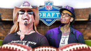 A celebratory graphic featuring Bret Michaels NFL Draft performer and Wiz Khalifa in front of a 2026 NFL Draft logo. On the left, Bret Michaels is seen laughing in a cowboy hat and sunglasses, wearing an "American Made" t-shirt. On the right, Wiz Khalifa wears a black baseball cap and glasses. The background shows a blurred football stadium, with the tops of two footballs visible in the foreground.
