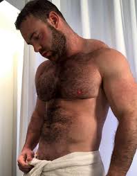Irish OnlyFans creator Jay Cottz posing wrapped in a white towel