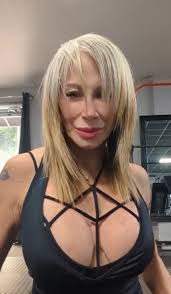 A direct head-and-shoulders portrait of Sonya Cortes with blonde hair, looking towards the camera. The setting appears to be a studio or casual space, which fits the aesthetic of content for Sonya Cortes's OnlyFans.