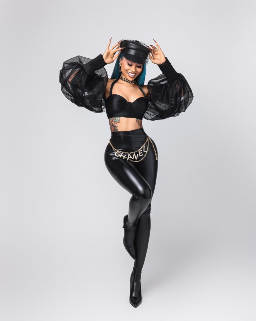 Blac Chyna seated on a stool wearing a black leather suit and hat, highlighted as a featured Lightskin OnlyFans creator.