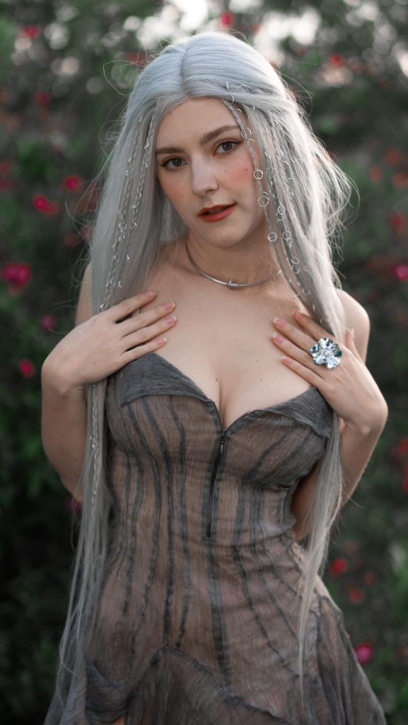 eva elfie posed in grey dress