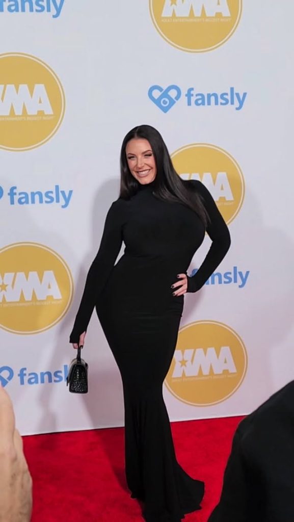 Angela White posing in a long black dress on a red carpet, widely cited as one of the best OnlyFans to buy for premium fan interactions.