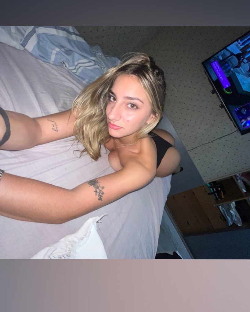 Blonde creator posing on a bed for the Best Free Trial OnlyFans page