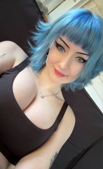 Selfie of a short blue-haired alternative creator, highlighted on a list of the best goth onlyfans pages.
