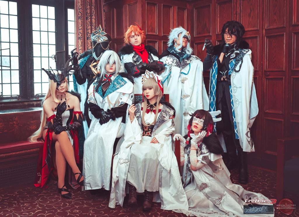 Group cosplay photo featuring the Fatui Harbingers in winter coats, representing the best Genshin Impact cosplay for villain characters.