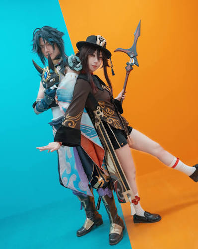 Duo cosplay showcasing Hu Tao and Xiao with detailed weapons, demonstrating the best Genshin Impact cosplay craftsmanship.