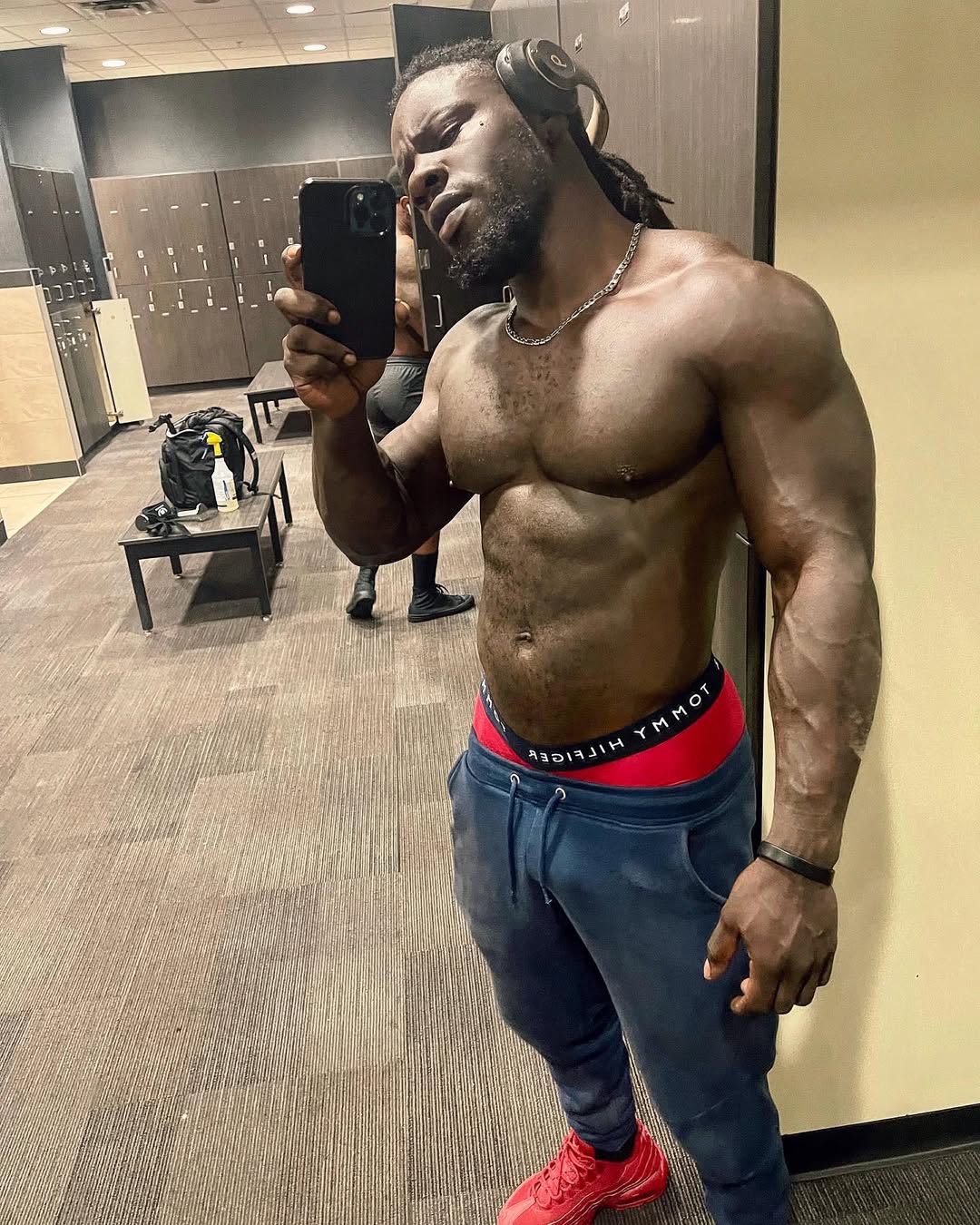 Athletic fitness model posing shirtless in a gym locker room to highlight the best black onlyfans creators.
