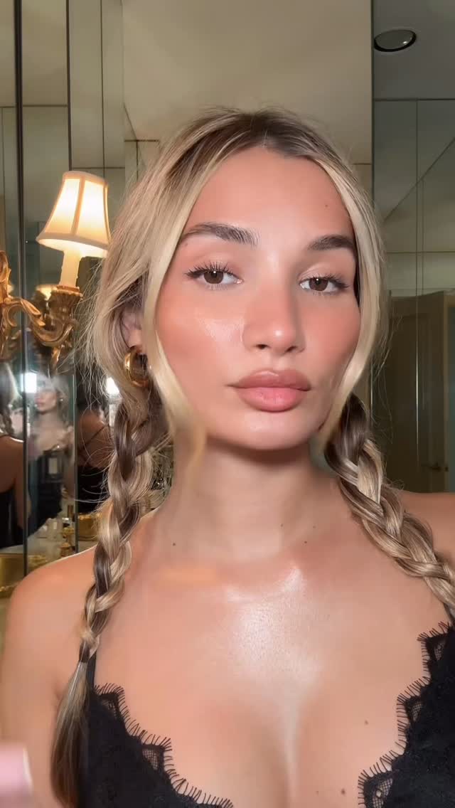 Close-up portrait of Pia Mia with braided blonde hair wearing a black lace top