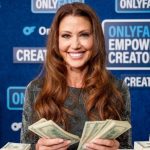 Shannon Elizabeth holding stacks of cash in front of an OnlyFans backdrop, illustrating the financial success of her Shannon Elizabeth OnlyFans account.