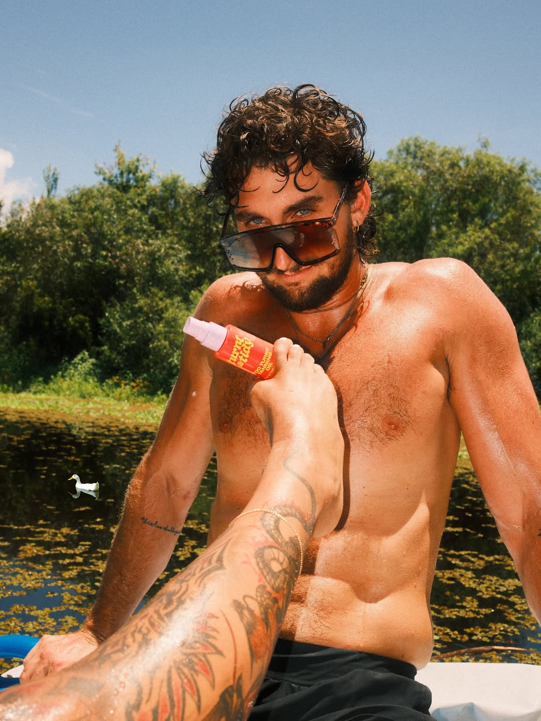 Shirtless man outdoors wearing sunglasses in sunny weather — Best Male OnlyFans creator