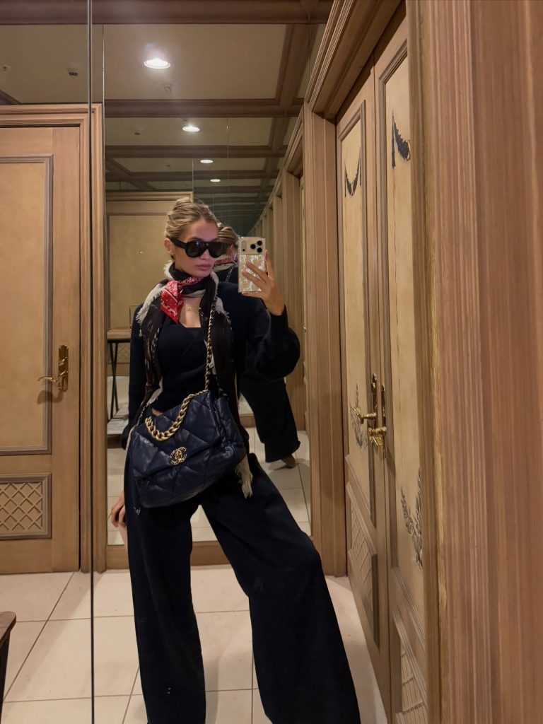 Pia Mia taking a mirror selfie wearing sunglasses, a black outfit, and a luxury purse for Pia Mia OnlyFans content.
