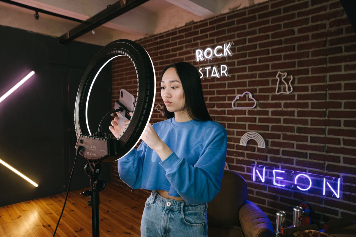 Social media influencer creating content with ring light setup