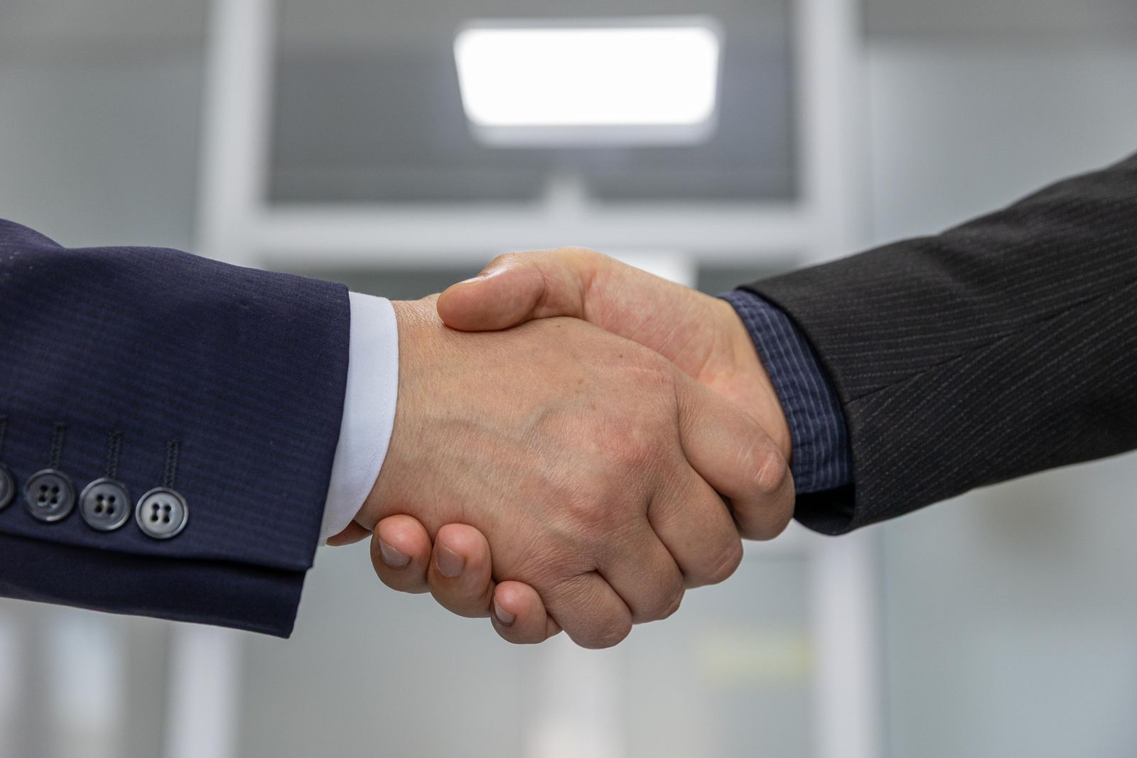 two business professionals shaking hands after a partnership agreement