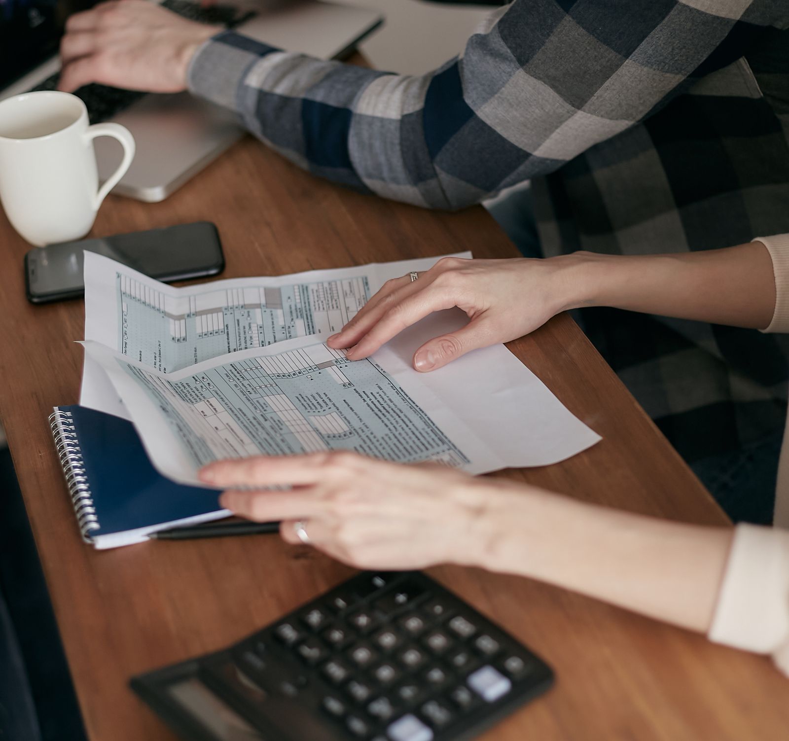 Tax forms and calculator representing OnlyFans creator self-employment tax obligations