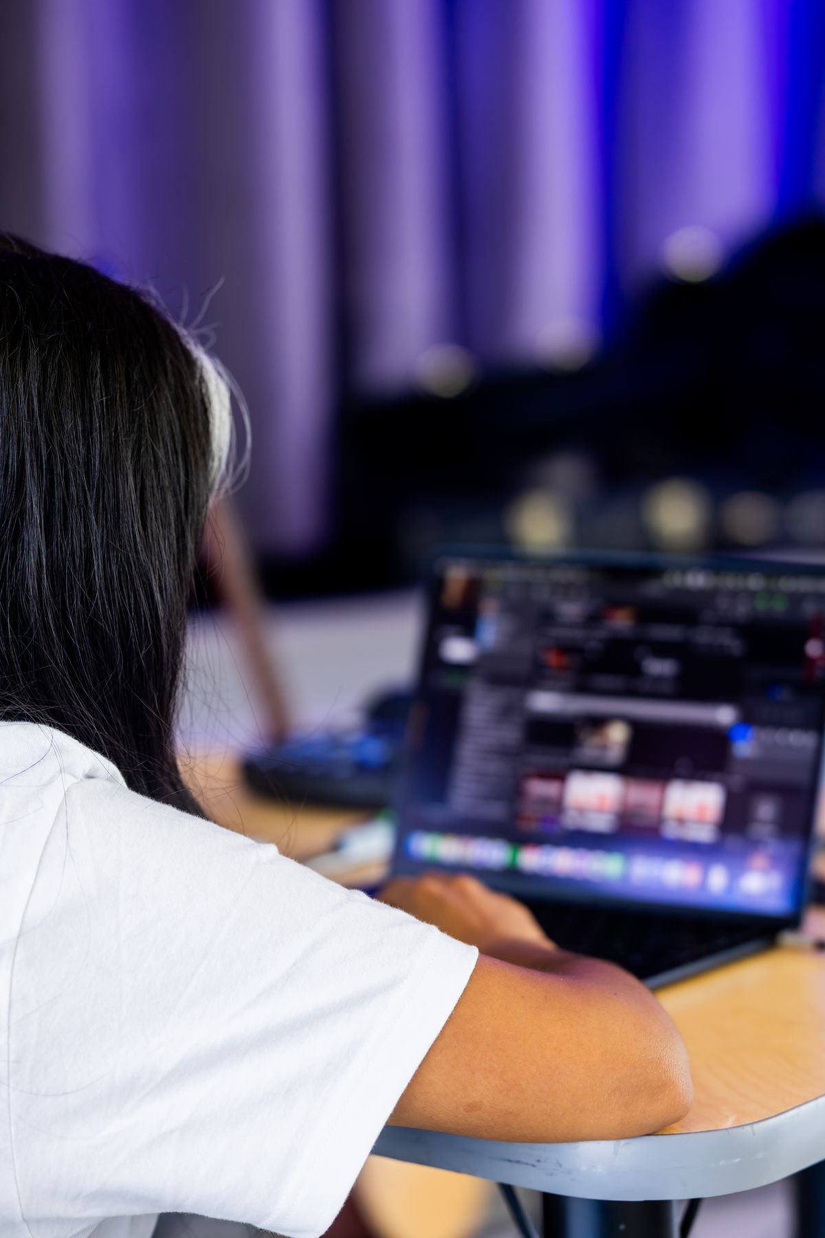 Creator editing video content on laptop in home studio