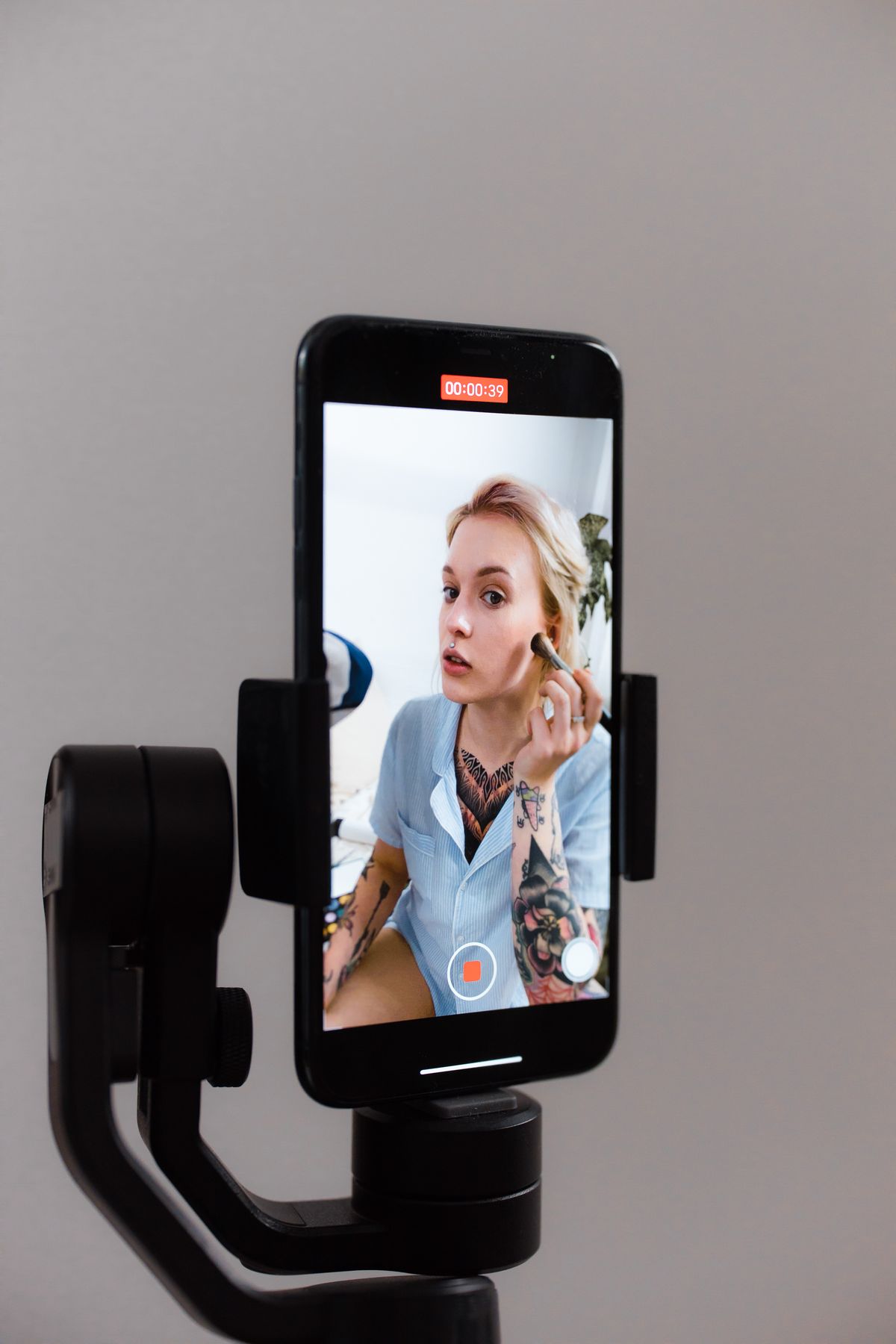 Woman recording content using smartphone on gimbal