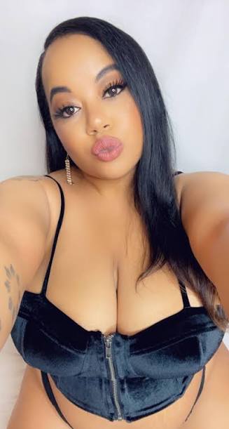 Kitti Karella in a black velvet zipped top