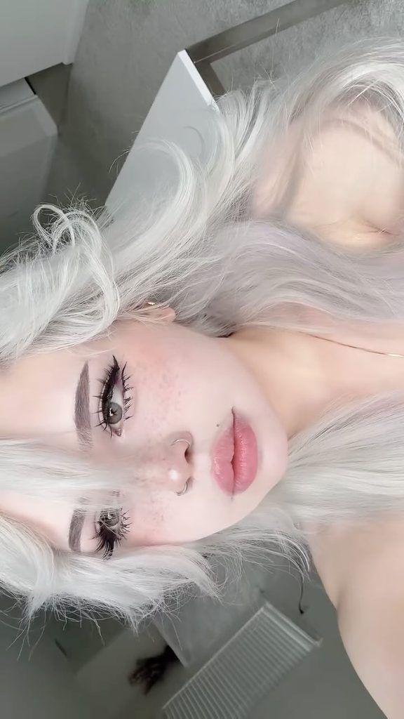 Close-up portrait of an e girl onlyfans influencer showing off her signature alternative makeup style