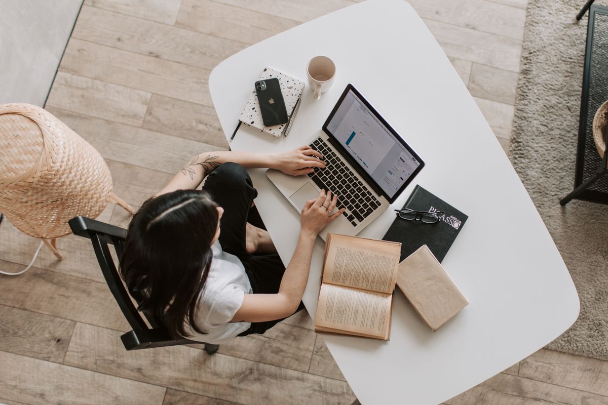 Content creator working on subscription-based revenue model at desk