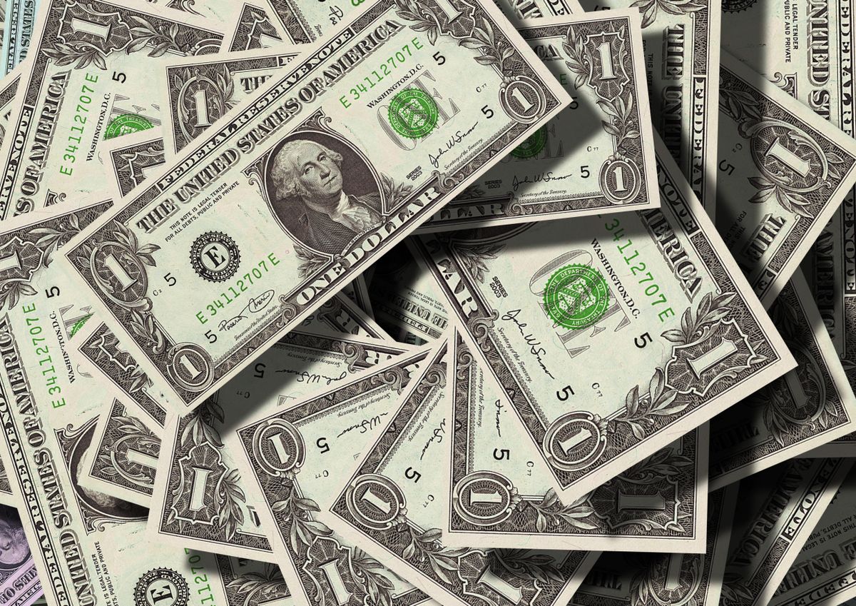 US dollar bills representing the $323 billion creator economy market in 2026