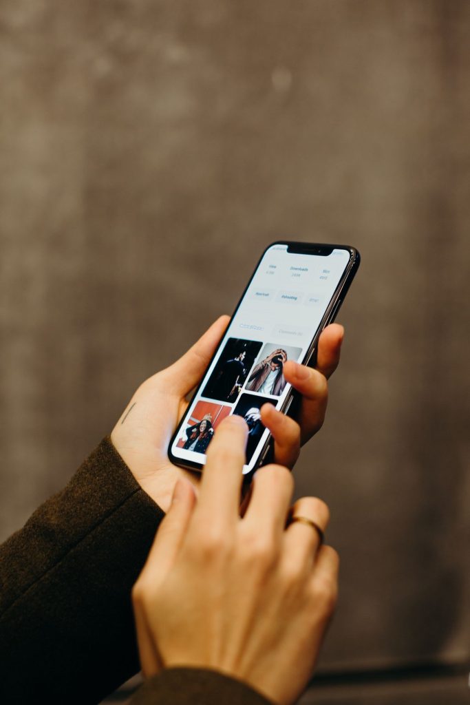 Person searching for OnlyFans creators on smartphone with social media apps visible
