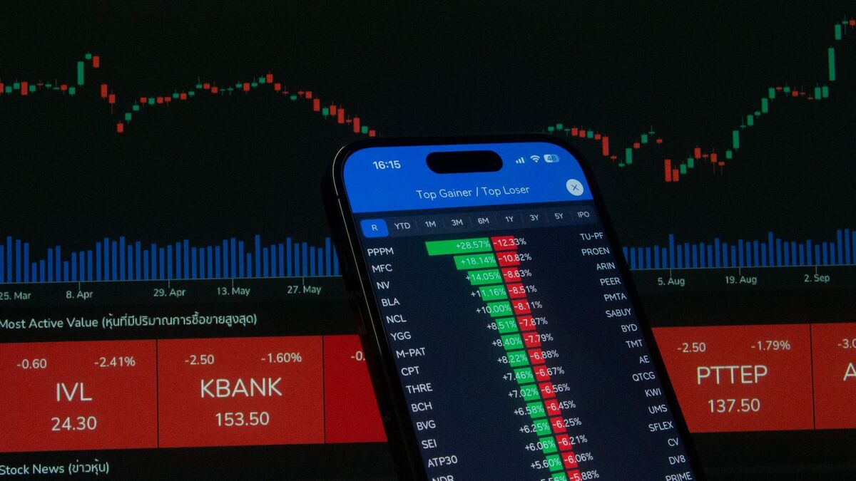 Smartphone displaying stock market growth data representing OnlyFans creator payout revenue