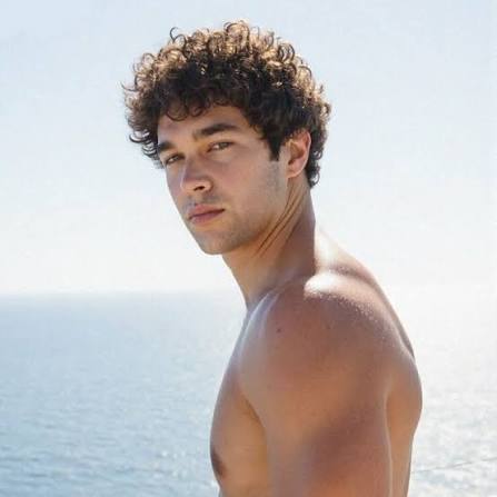 Austin Mahone outdoors by the water, featured in articles covering YouTubers With OnlyFans.