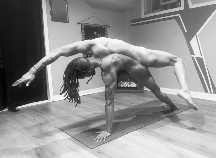 Marcus Stanback performing an advanced yoga balance pose, highlighted among Yoga OnlyFans creators.