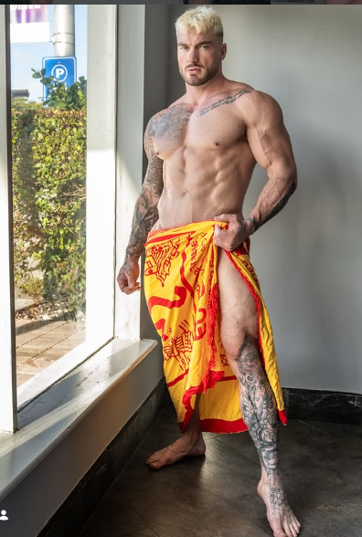 William Seed posing indoors wrapped in a patterned towel, featured among top creators on Canadian OnlyFans